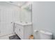 Well-lit bathroom featuring double sinks, white cabinets, and modern fixtures at 125 Links Terrace Blvd, Daytona Beach, FL 32124