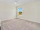 Bedroom with a neutral color scheme and a view of the outdoors through a window at 125 Links Terrace Blvd, Daytona Beach, FL 32124