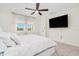 Cozy primary bedroom boasts a large window with backyard view and a ceiling fan at 125 Links Terrace Blvd, Daytona Beach, FL 32124