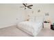 Spacious bedroom features plush carpet, a ceiling fan, and ample natural light at 125 Links Terrace Blvd, Daytona Beach, FL 32124