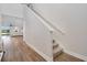 Entryway staircase with wood floors adjacent to a living area with lake views at 125 Links Terrace Blvd, Daytona Beach, FL 32124