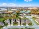 Aerial view of neighborhood with homes, highlighting the surrounding green spaces and nearby city buildings at 1298 Patterson Ter, Lake Mary, FL 32746