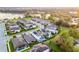 Aerial view of a neighborhood featuring well-maintained homes, lush greenery, and a serene lake backdrop at 1298 Patterson Ter, Lake Mary, FL 32746