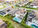 Aerial view of a backyard with pool and spa, complemented by landscaped yard and manicured hedges at 1298 Patterson Ter, Lake Mary, FL 32746