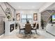 Cozy dining area featuring modern decor, a fireplace, a round table with seating, and stylish wall accents at 1298 Patterson Ter, Lake Mary, FL 32746