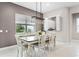 Bright dining room with a modern chandelier and large window overlooking a landscaped yard at 1298 Patterson Ter, Lake Mary, FL 32746