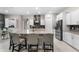 Modern kitchen featuring a large island with seating, stainless steel appliances, and stylish pendant lighting at 1298 Patterson Ter, Lake Mary, FL 32746