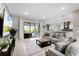 Bright and airy living room with a view of the outdoors, with an adjacent modern kitchen and dining space at 1298 Patterson Ter, Lake Mary, FL 32746