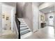 Modern staircase with LED lighting, decorative wrought iron, adjacent to the home's front entryway at 1298 Patterson Ter, Lake Mary, FL 32746