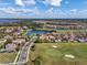 Aerial view of a community with beautiful homes, a golf course, and lakes at 13106 Alderley Dr, Orlando, FL 32832