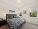 Comfortable bedroom featuring a patterned bedspread, natural light from two windows, and dark wood furniture at 13106 Alderley Dr, Orlando, FL 32832