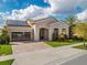 Charming single-story home with a paver driveway, tile roof, and well-maintained landscaping at 13106 Alderley Dr, Orlando, FL 32832