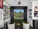 Golf simulator room with comfortable seating and sports memorabilia at 13106 Alderley Dr, Orlando, FL 32832