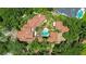 Aerial view of estate showcasing tile roof, pool, meticulously manicured grounds and mature trees at 1400 Alabama Dr, Winter Park, FL 32789