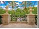 Outdoor balcony view with decorative stone pillars, wrought iron railing, and palm tree scenery at 1400 Alabama Dr, Winter Park, FL 32789