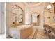 Luxury bathroom with marble accents, a soaking tub, vanity, and custom mirrors at 1400 Alabama Dr, Winter Park, FL 32789