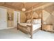 Spacious bedroom showcasing a four-poster bed, decorative walls and tray ceiling at 1400 Alabama Dr, Winter Park, FL 32789