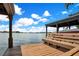 View of a covered boat dock with a bench, offering a serene spot by the water at 1400 Alabama Dr, Winter Park, FL 32789