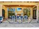 Outdoor dining area with a fireplace, TV, chandelier, and stone tile flooring at 1400 Alabama Dr, Winter Park, FL 32789