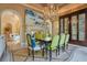 Formal dining room with a large chandelier, a fireplace, and elegant decor at 1400 Alabama Dr, Winter Park, FL 32789