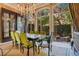 Sunlit dining room with a large windows offering tranquil views of the lush gardens at 1400 Alabama Dr, Winter Park, FL 32789