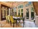 Bright dining room with large windows, a chandelier, and a view of the landscaped backyard at 1400 Alabama Dr, Winter Park, FL 32789