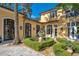 Exterior view of the house with a landscaped yard, manicured hedges, and elegant courtyard at 1400 Alabama Dr, Winter Park, FL 32789