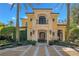 Beautiful front exterior showcasing the home's architecture with a stone facade, arched entryway, and manicured landscaping at 1400 Alabama Dr, Winter Park, FL 32789