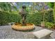 Ornate fountain surrounded by lush greenery and stone benches in a serene garden setting at 1400 Alabama Dr, Winter Park, FL 32789