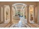 Grand foyer with marble flooring, decorative columns, and a coffered ceiling offering a luxurious and welcoming entrance at 1400 Alabama Dr, Winter Park, FL 32789