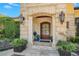 Elegant stone entryway featuring a dark wood door with decorative glass and stylish outdoor lighting at 1400 Alabama Dr, Winter Park, FL 32789