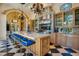 A gourmet kitchen features a large island with seating, professional appliances, and decorative chandeliers at 1400 Alabama Dr, Winter Park, FL 32789