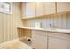 A practical laundry room featuring cabinetry, a sink, and ample counter space at 1400 Alabama Dr, Winter Park, FL 32789