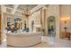 Grand living room with fireplace, piano and large arched windows offering an abundance of natural light at 1400 Alabama Dr, Winter Park, FL 32789