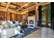 Living room featuring a fireplace, a large screen TV, a chandelier, and patio doors with a backyard view at 1400 Alabama Dr, Winter Park, FL 32789