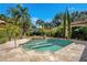 Lovely pool with a tanning ledge, surrounded by lush landscaping, creating a private backyard retreat at 1400 Alabama Dr, Winter Park, FL 32789