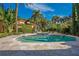 Backyard pool featuring lush landscaping, blue tile trim, and an elegant fountain at 1400 Alabama Dr, Winter Park, FL 32789