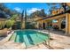 Backyard pool and patio area, with outdoor dining, grilling area, and lush landscaping at 1400 Alabama Dr, Winter Park, FL 32789