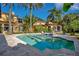 Beautiful pool with a sun shelf, surrounded by lush landscaping and a luxury home at 1400 Alabama Dr, Winter Park, FL 32789