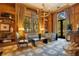 Sitting room with wood walls, a chandelier, patterned furniture, and large windows at 1400 Alabama Dr, Winter Park, FL 32789