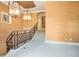 A view of the carpeted staircase with decorative railings and hanging chandeliers at 1400 Alabama Dr, Winter Park, FL 32789