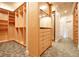 Organized walk-in closet features natural wood shelves, drawers, and a full-length mirror for efficient wardrobe management at 1400 Alabama Dr, Winter Park, FL 32789