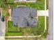 This aerial view showcases a home with a well-maintained yard, driveway, and landscaping at 1609 River Birch Ave, Oviedo, FL 32765