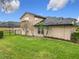 View of the home's well-maintained, fenced backyard with mature trees and landscaping at 1609 River Birch Ave, Oviedo, FL 32765