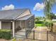 View of the home's screened-in lanai and fenced backyard with mature landscaping at 1609 River Birch Ave, Oviedo, FL 32765