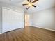 This bedroom has laminate wood floors, a walk-in closet and ceiling fan at 1609 River Birch Ave, Oviedo, FL 32765