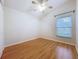 Well-lit bedroom with a large window with blinds and wood-look flooring at 1609 River Birch Ave, Oviedo, FL 32765