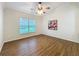 Bedroom with wood flooring, fan, and large window at 1609 River Birch Ave, Oviedo, FL 32765