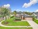 Well-manicured lawn and shrubbery in the front of an attractive home in residential neighborhood at 1609 River Birch Ave, Oviedo, FL 32765