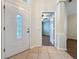 Well-lit foyer featuring tile floors, glass-paneled front door, and view into next room at 1609 River Birch Ave, Oviedo, FL 32765